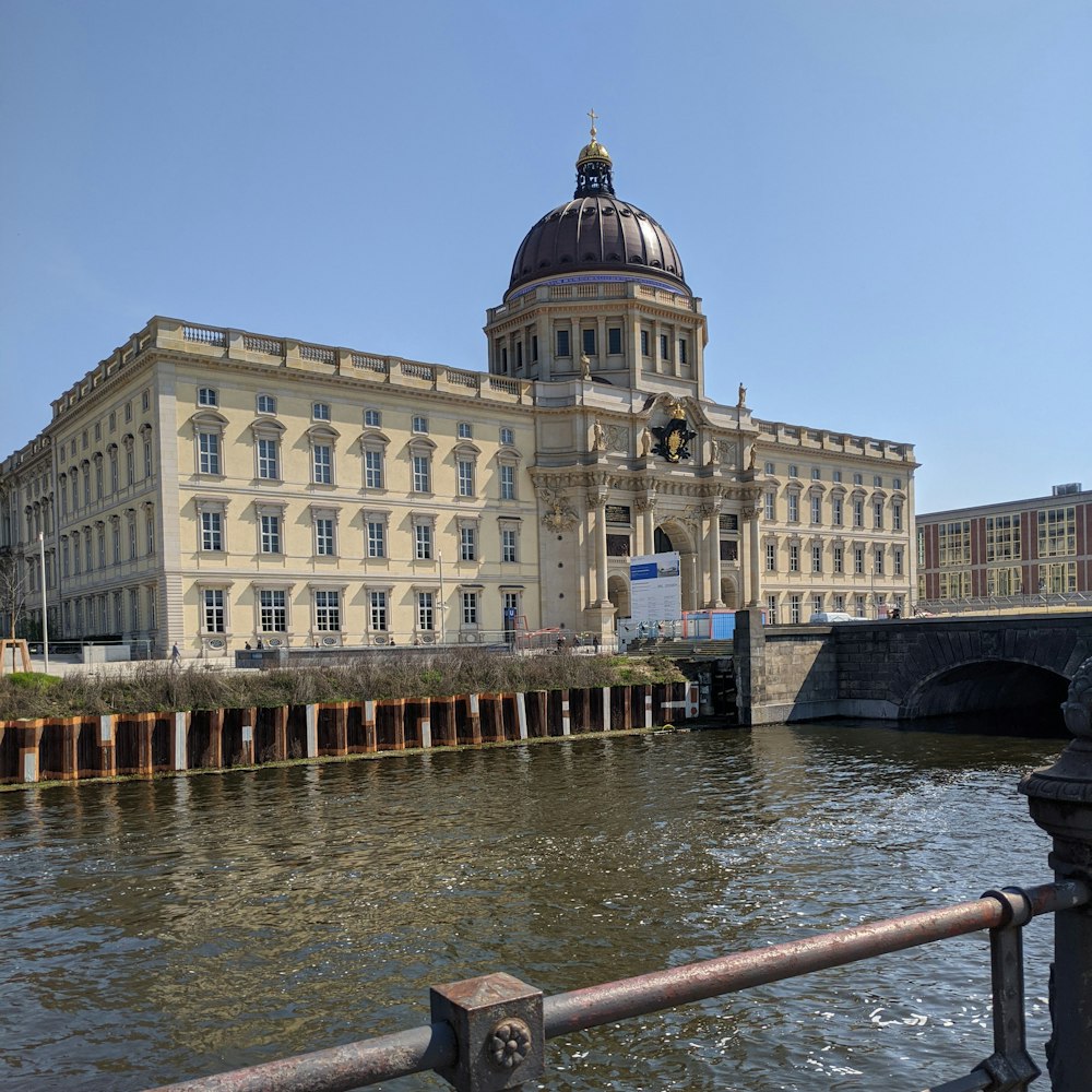 a large building sitting on the side of a river