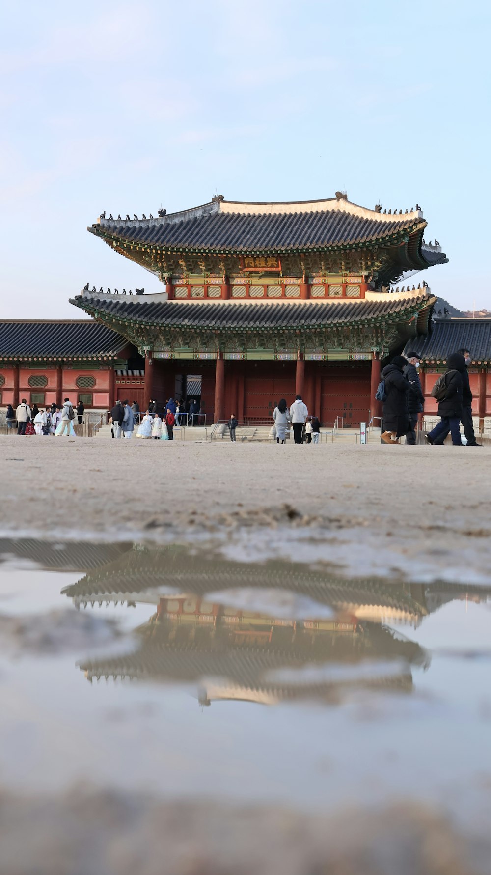 a group of people walking around a building