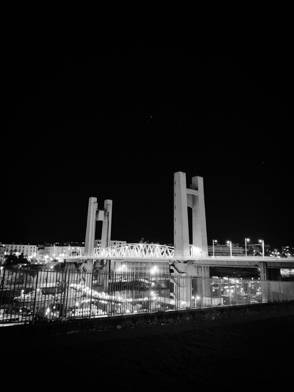 a black and white photo of a city at night