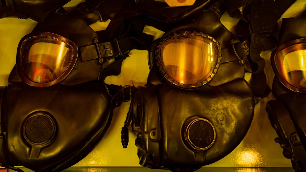 a group of gas masks hanging on a wall