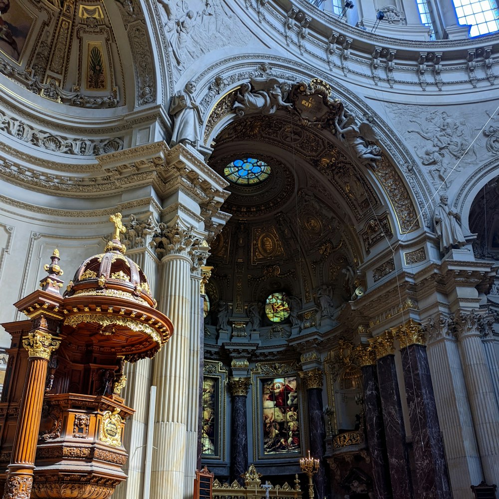 a church with a large alter and a stained glass window