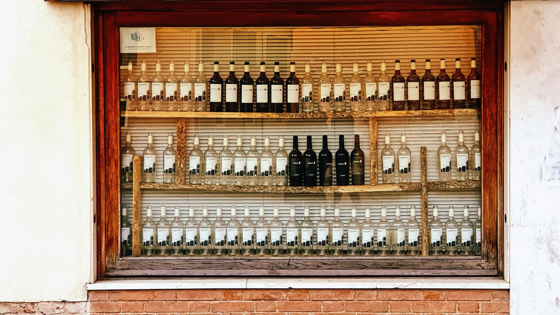 bottles of wine are on display in a window