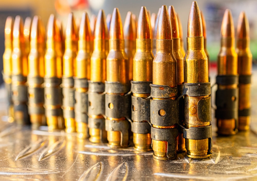 a bunch of bullet shells lined up on a table