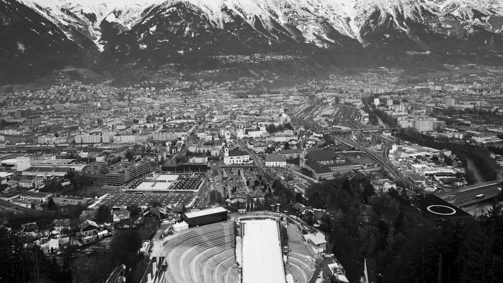 an aerial view of a city with mountains in the background