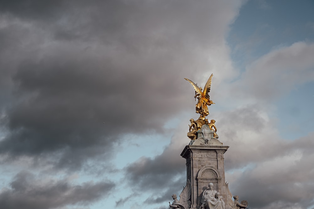 a statue of an angel on top of a building