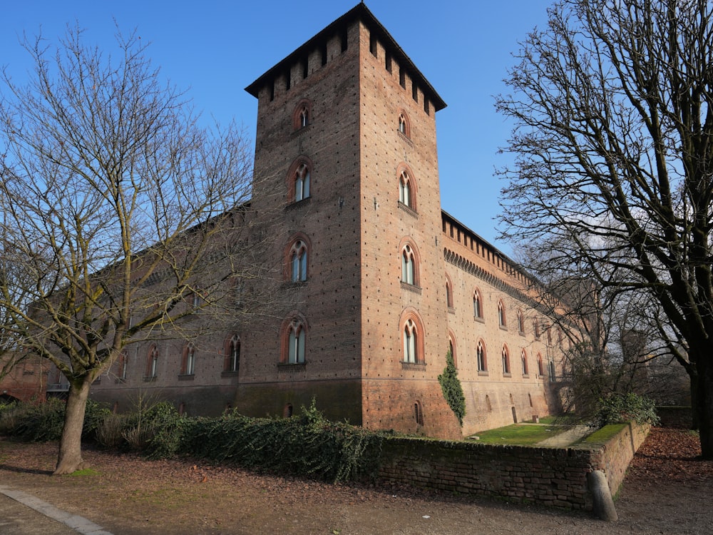 a tall brick building with a clock on the top of it