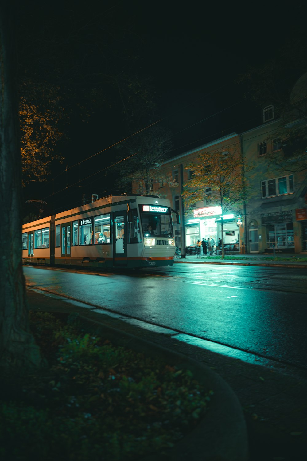 a trolley on a city street at night