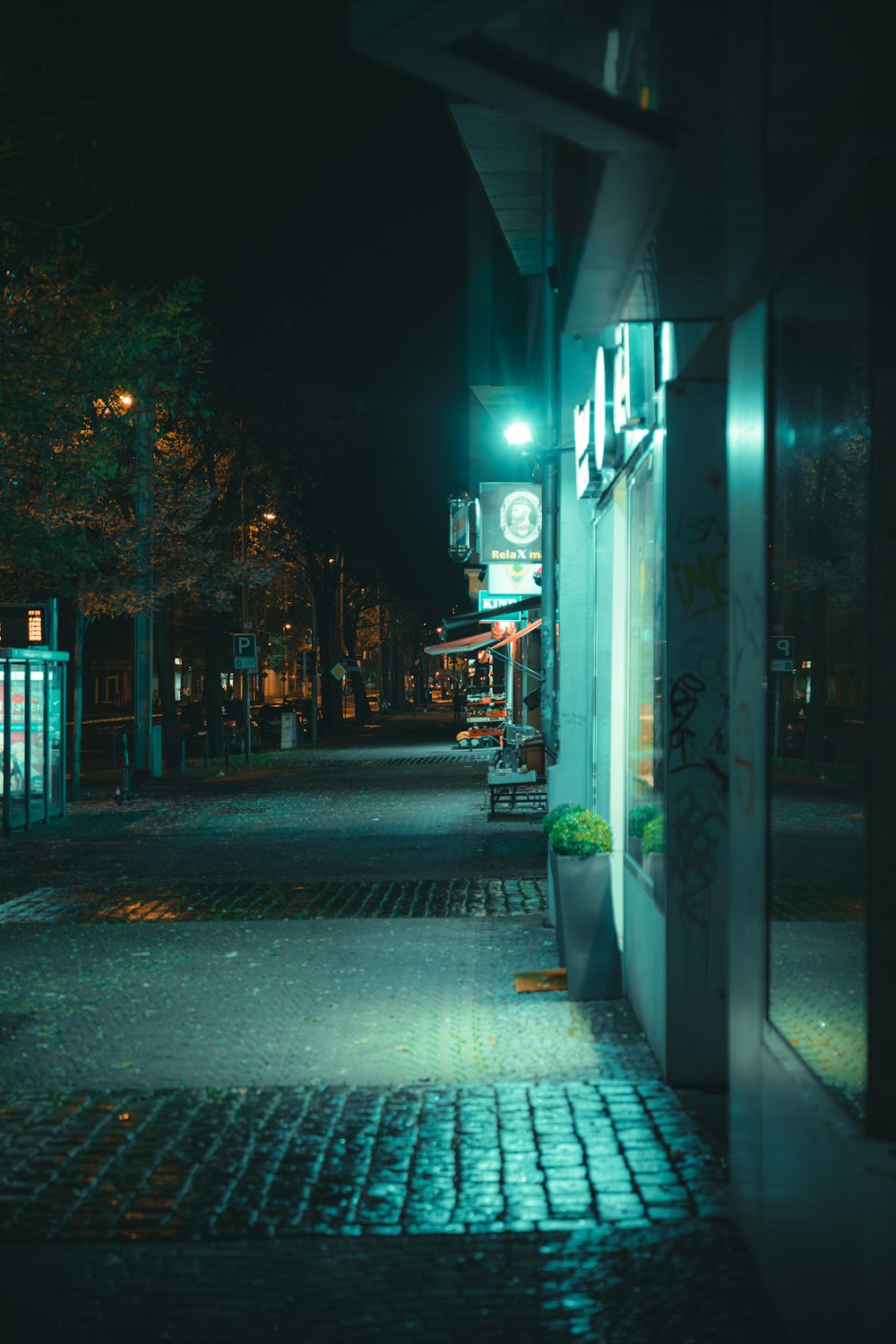 a city street at night with a green light