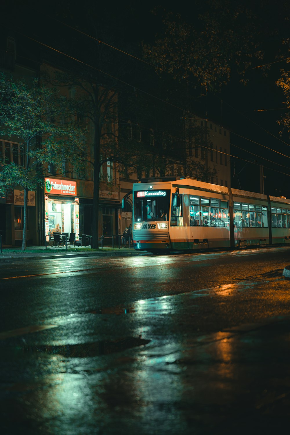 a city bus on a city street at night
