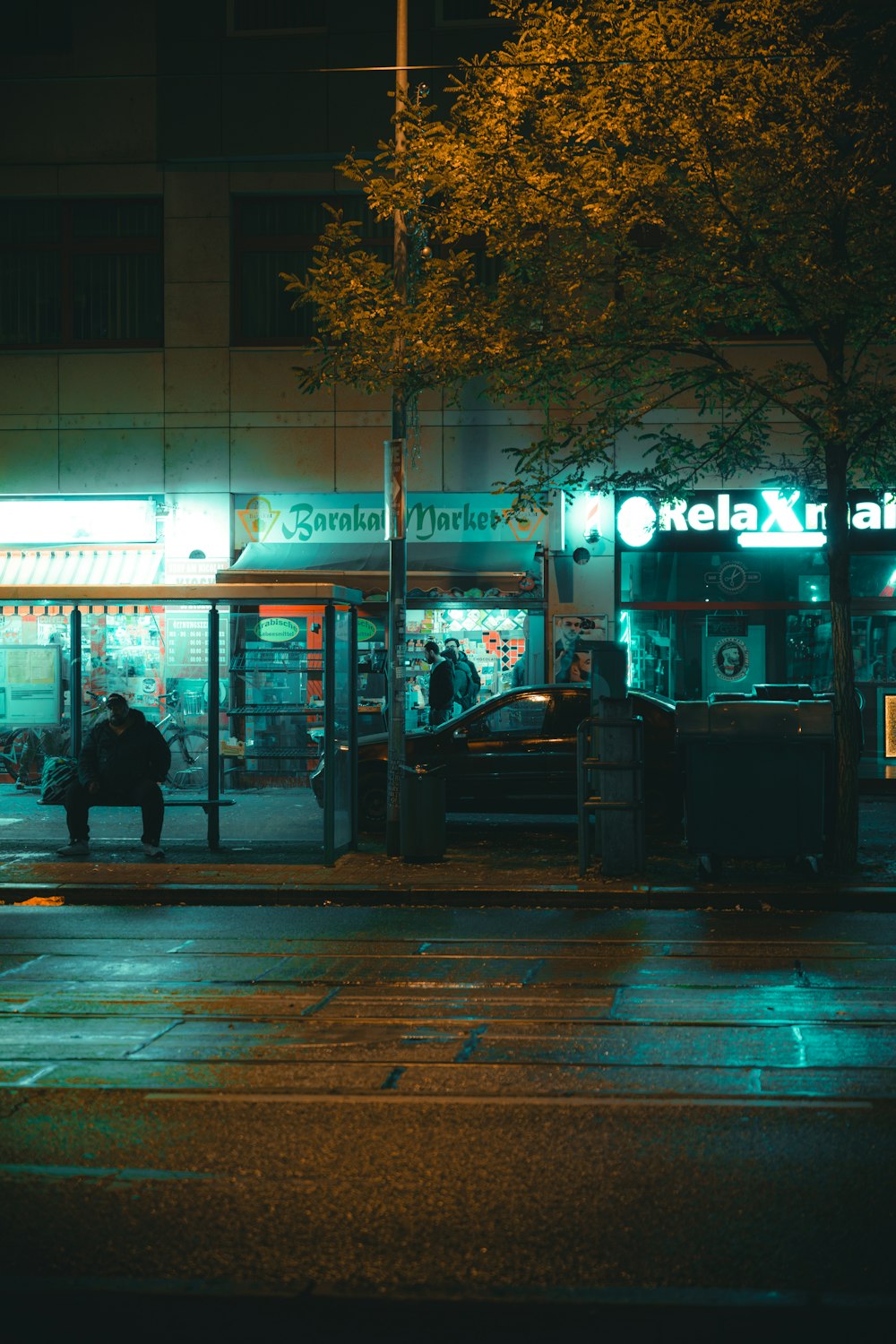 a person sitting on a bench in front of a store