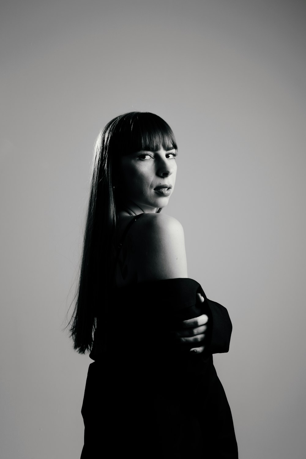 a black and white photo of a woman in a dress