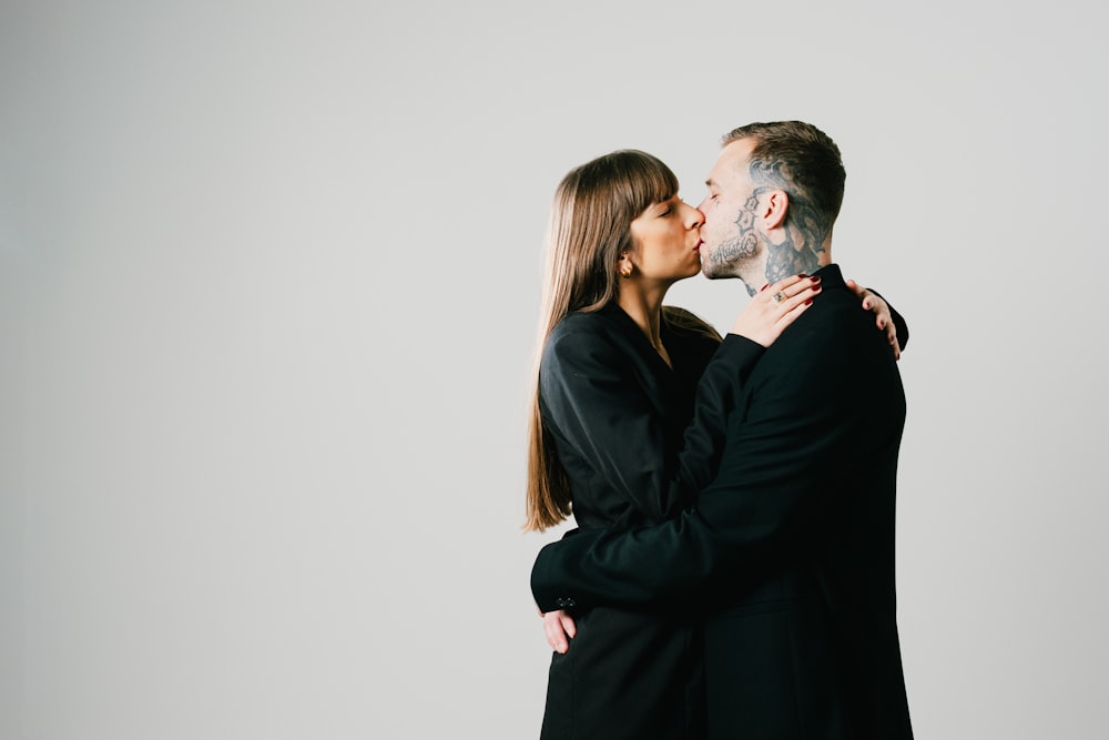 a man and a woman kissing each other