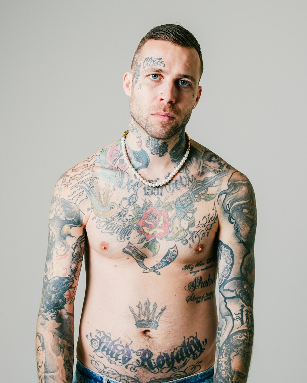 a man with a lot of tattoos on his chest