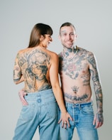 a tattooed man and woman posing for a picture