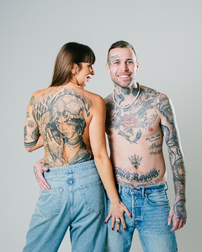 a tattooed man and woman posing for a picture