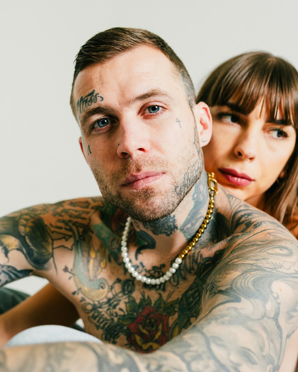 a tattooed man and woman posing for a picture