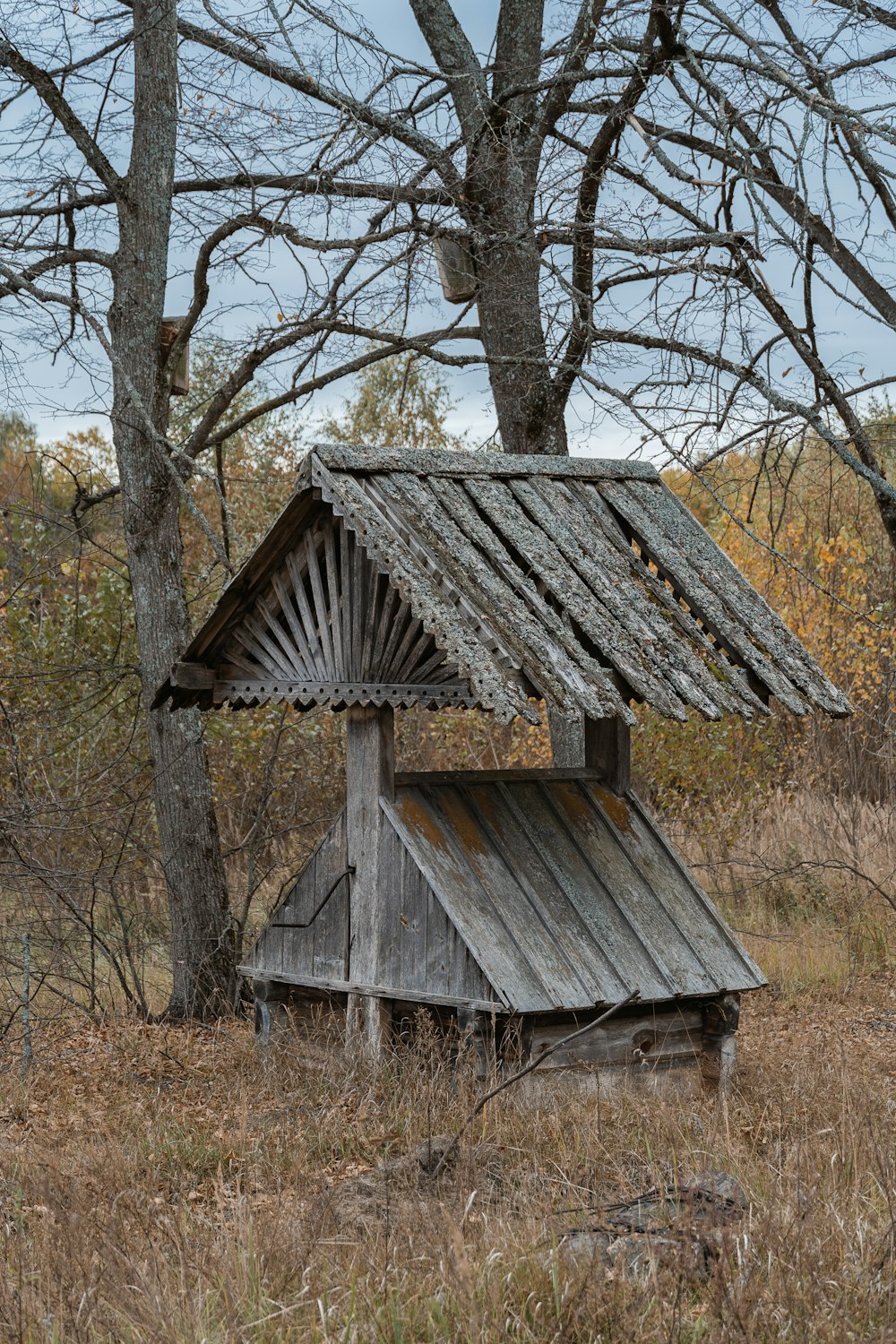 an old outhouse in the middle of a field