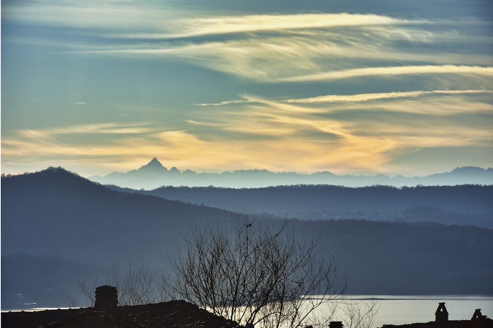 a view of a mountain range with a lake in the foreground