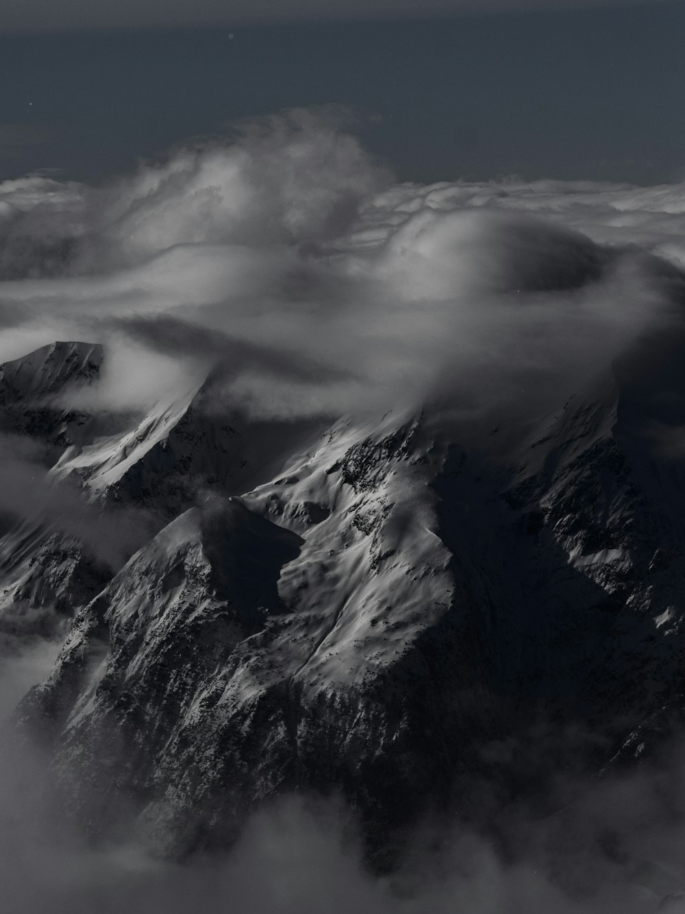 a black and white photo of a mountain range