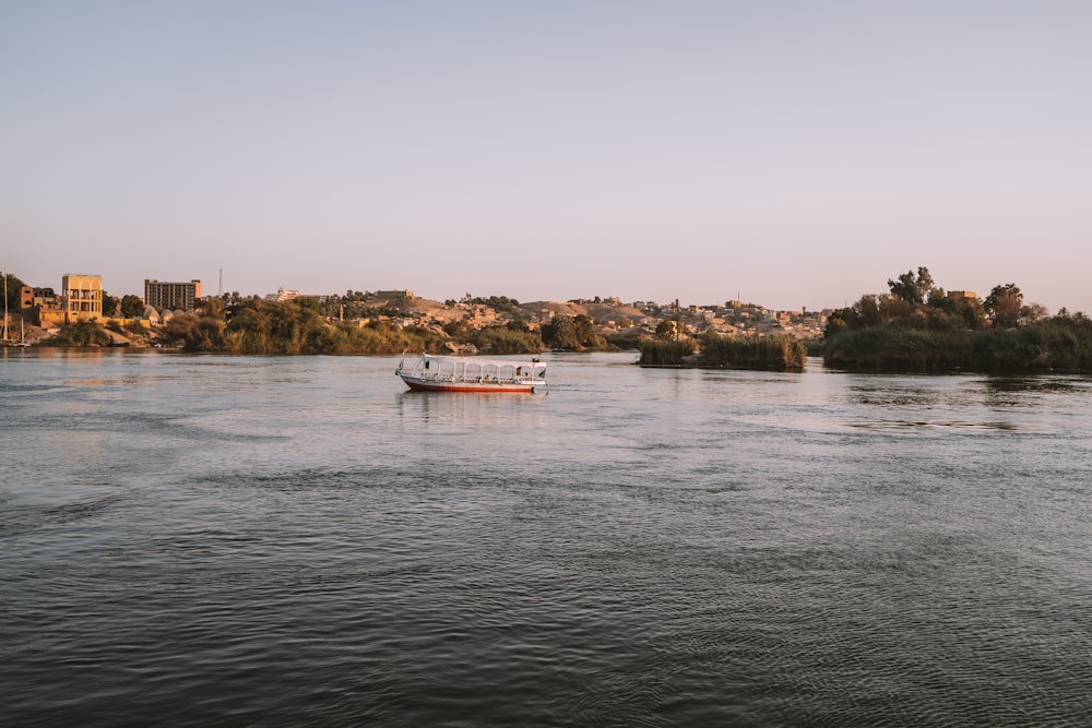 a boat on a river with a city in the background