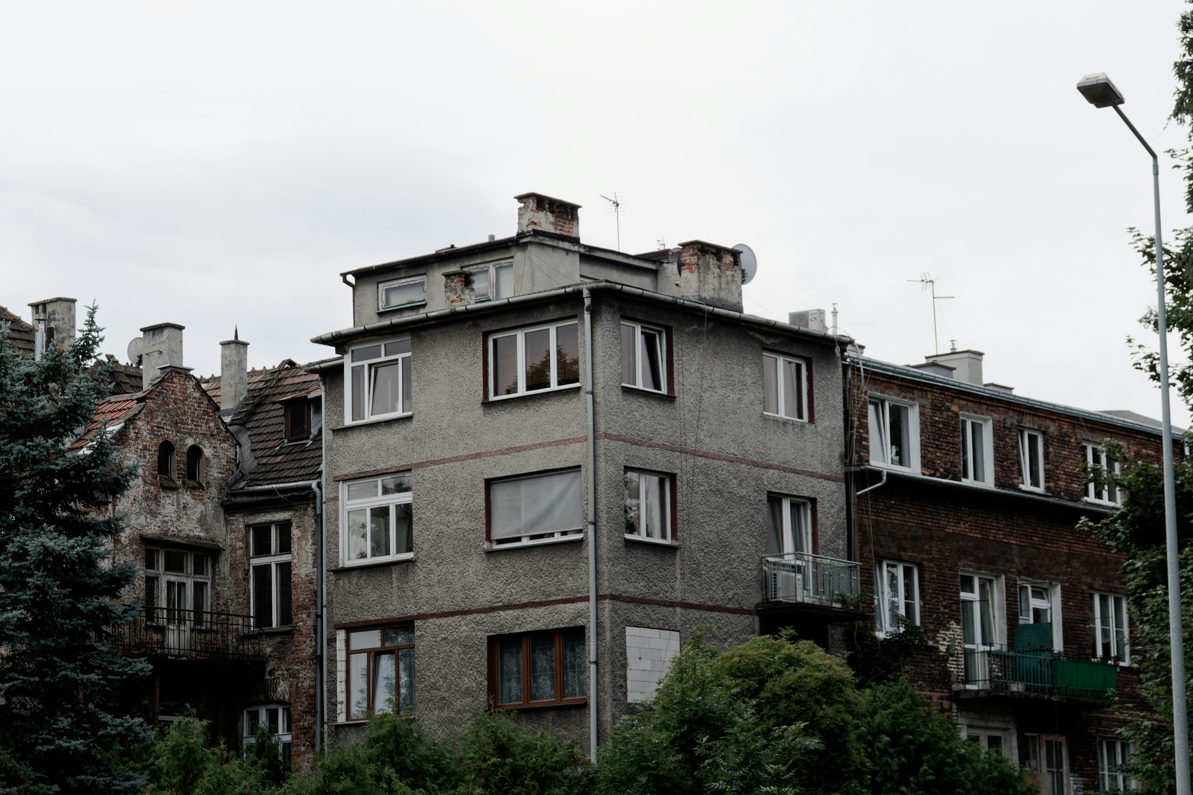 a tall building with lots of windows next to trees