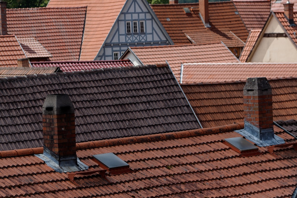 a row of rooftops with a clock tower in the background