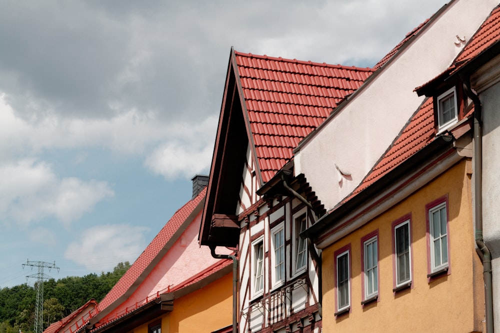 a row of houses with red roofs and white windows