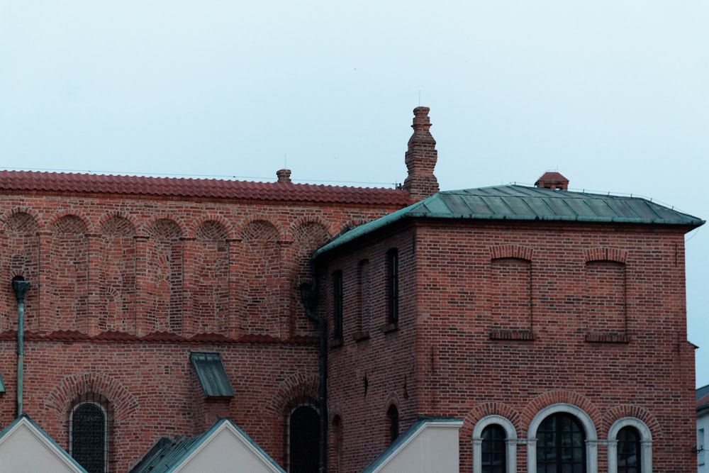 a large brick building with a green roof