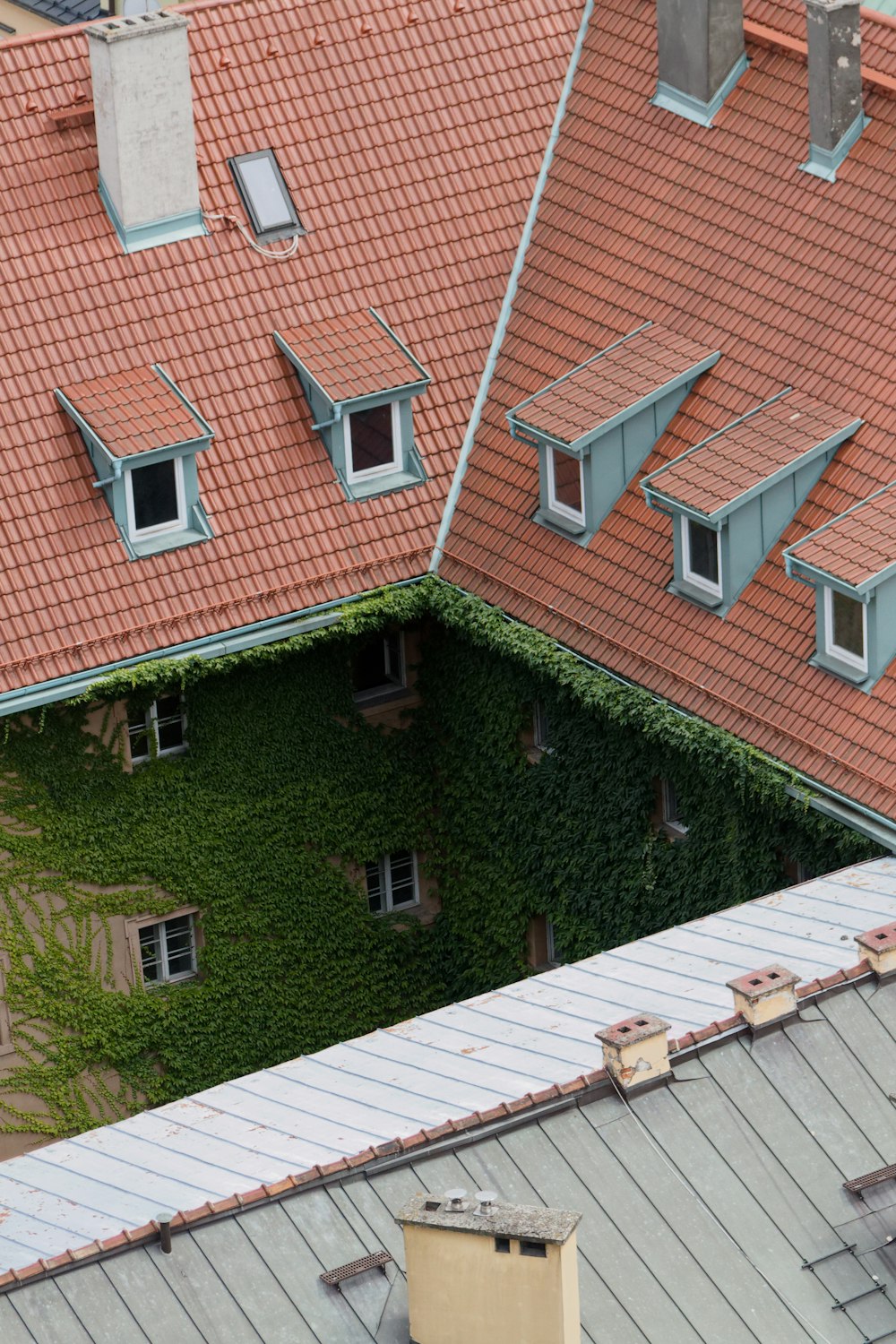 an aerial view of a building with a red roof