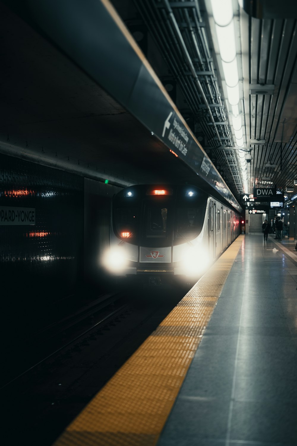 a train pulling into a train station at night