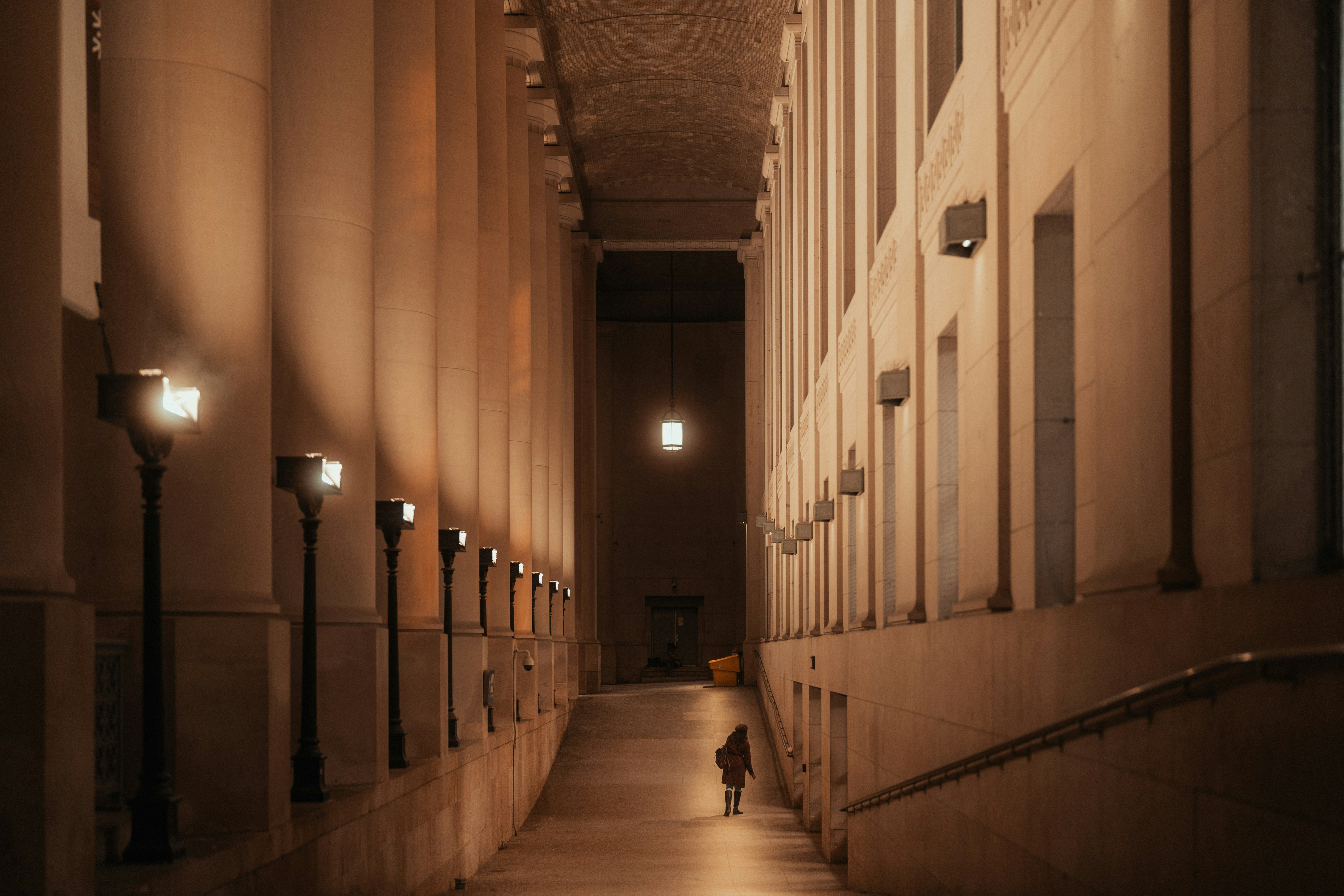 a person walking down a hallway in a building