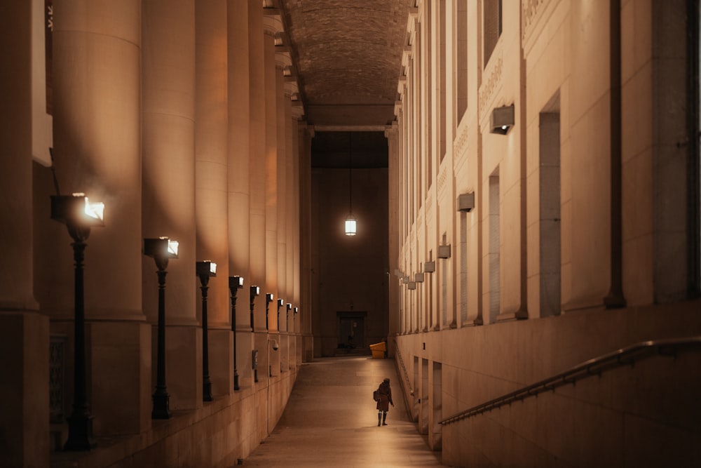 a person walking down a hallway in a building