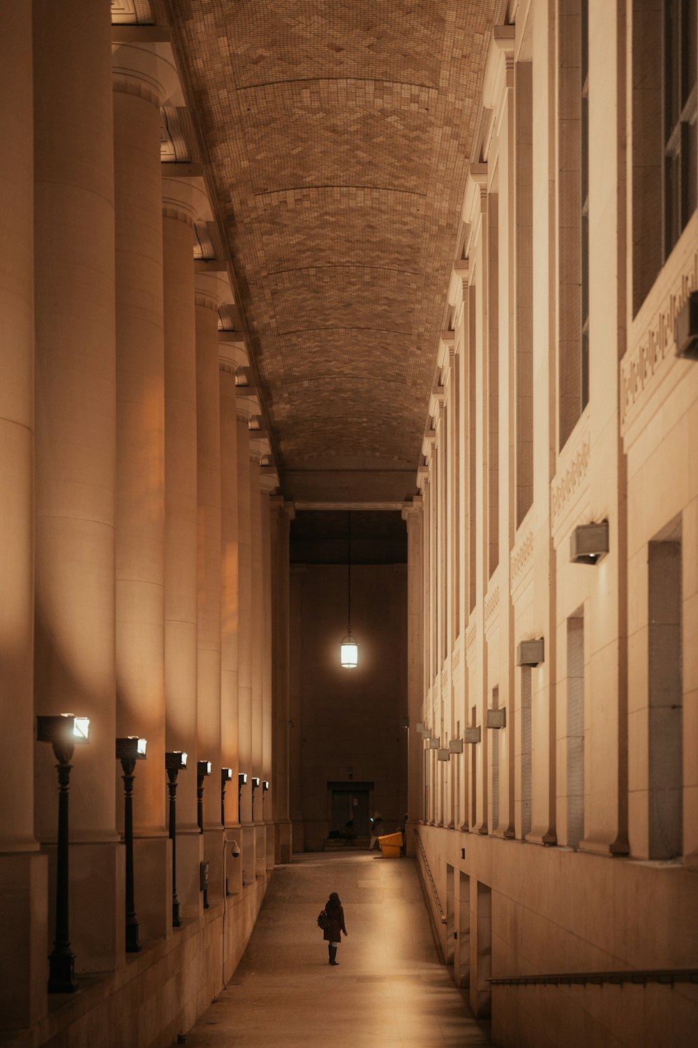 a person walking down a hallway in a building