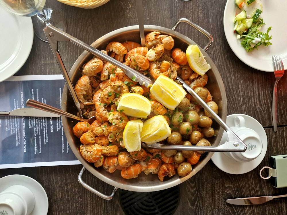 a bowl of food on a table with utensils