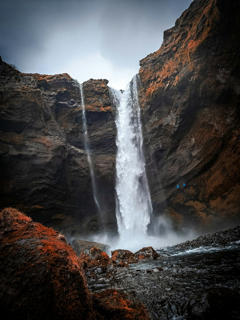 a large waterfall is seen from the ground