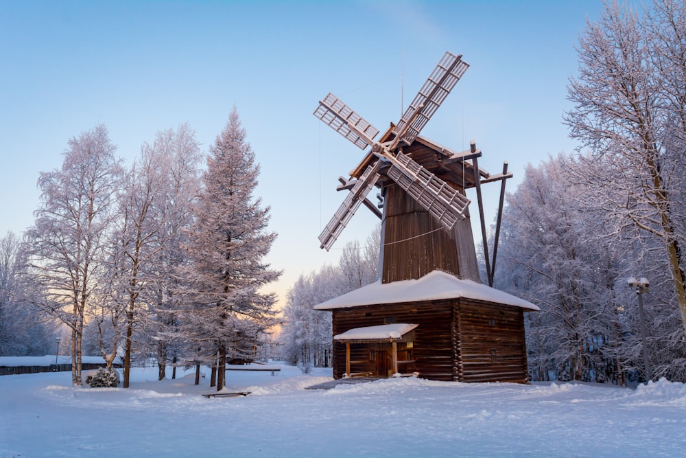 a windmill in the middle of a snowy field