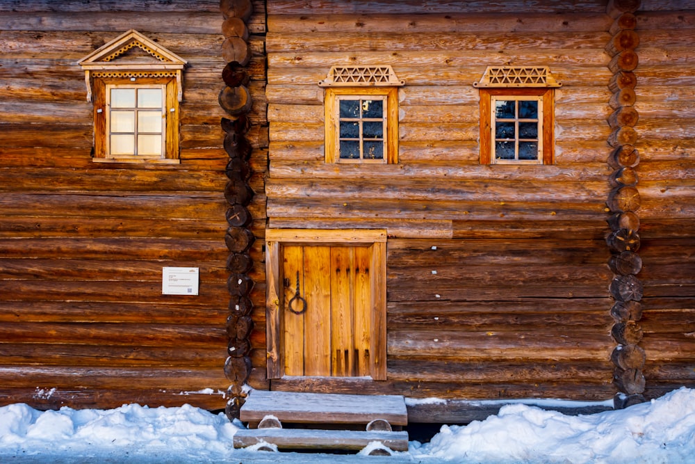 a log cabin with a bench in front of it