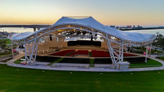 a large white tent sitting on top of a lush green field