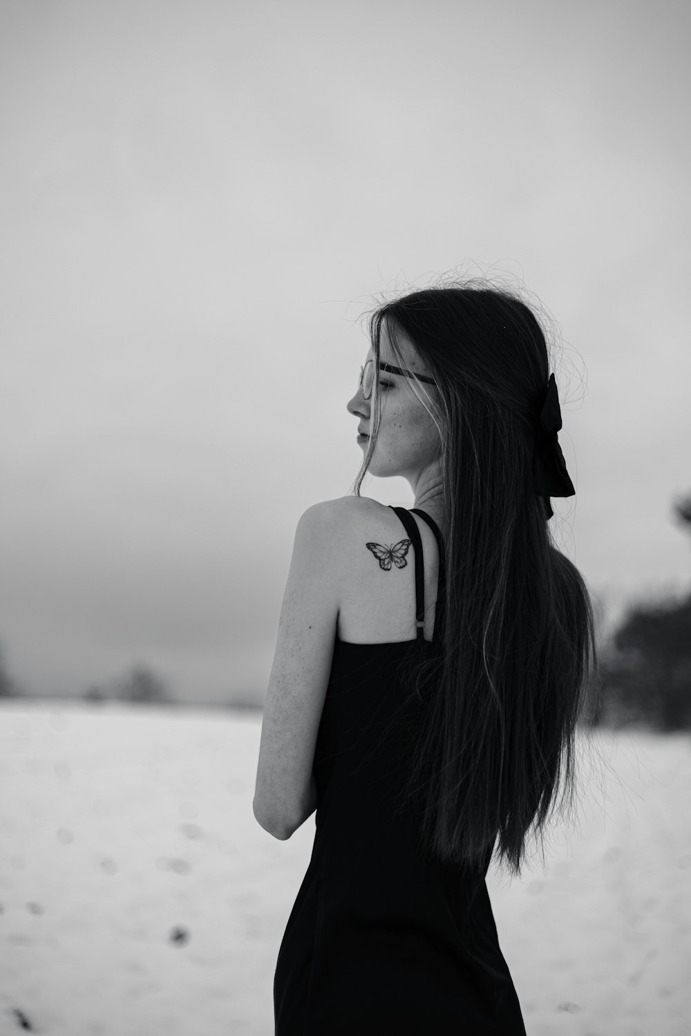 a woman with long hair standing in the snow