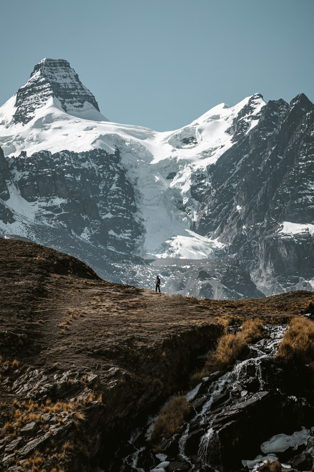 a person standing on top of a snow covered mountain