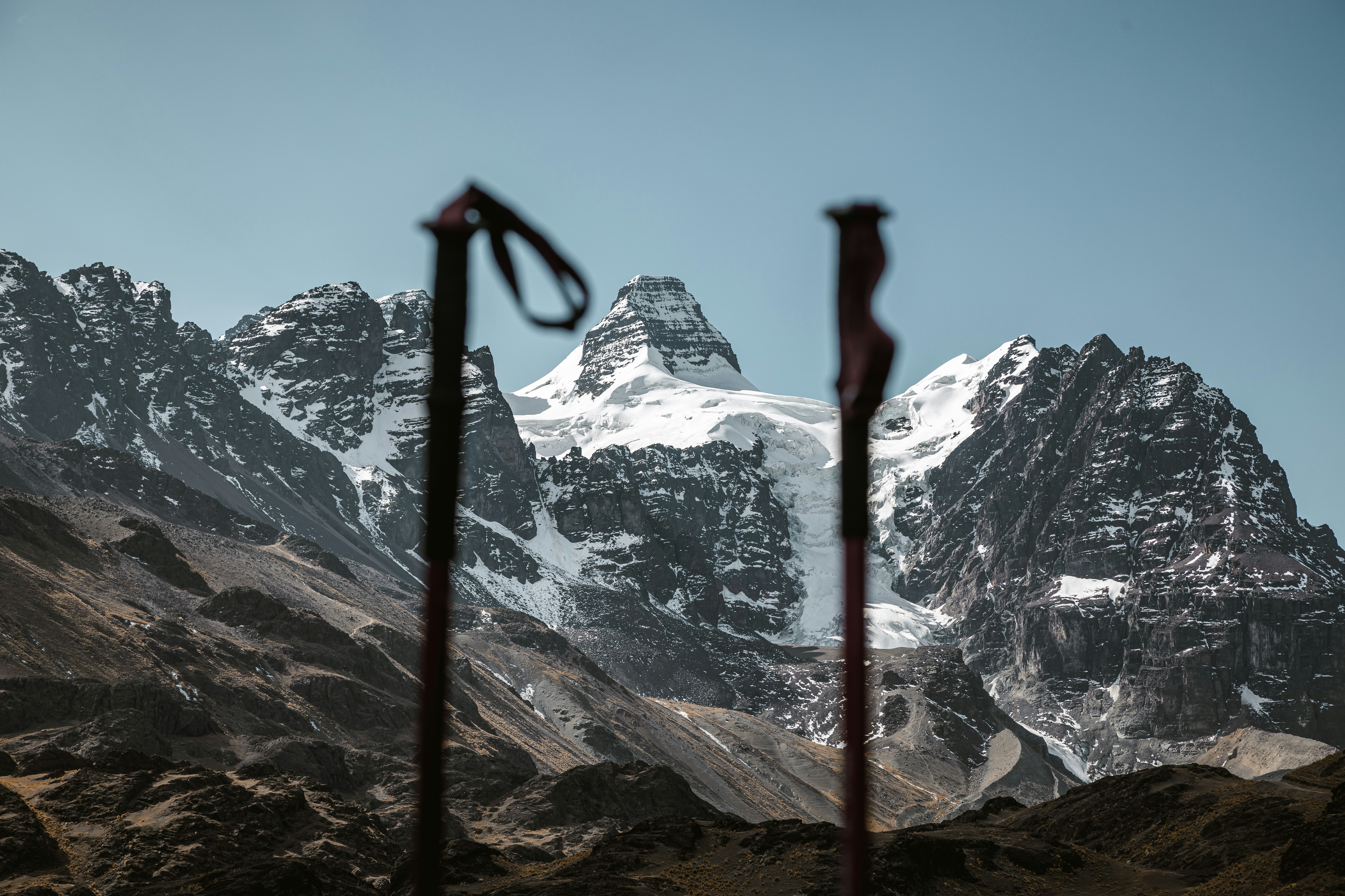 Hikers on a mountain ridge using trekking poles