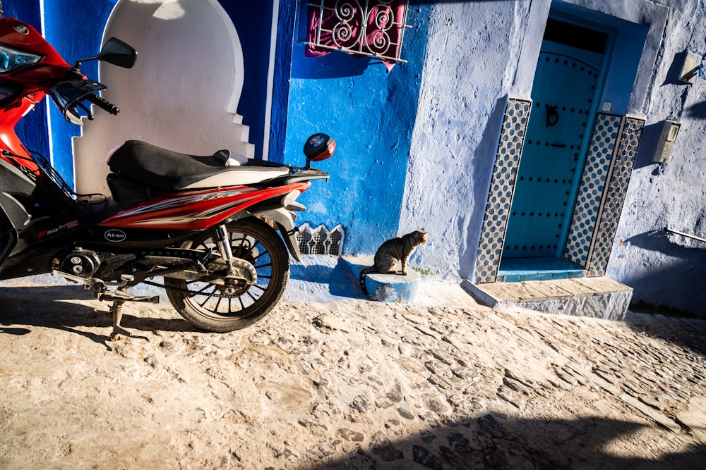 a motorcycle parked in front of a blue building