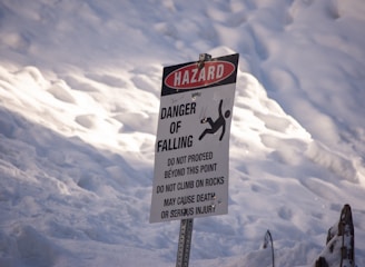 a sign warning of danger of falling in the snow