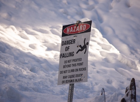a sign warning of danger of falling in the snow