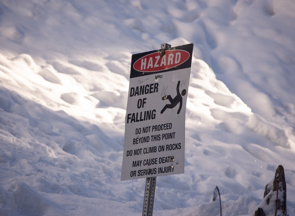 a sign warning of danger of falling in the snow