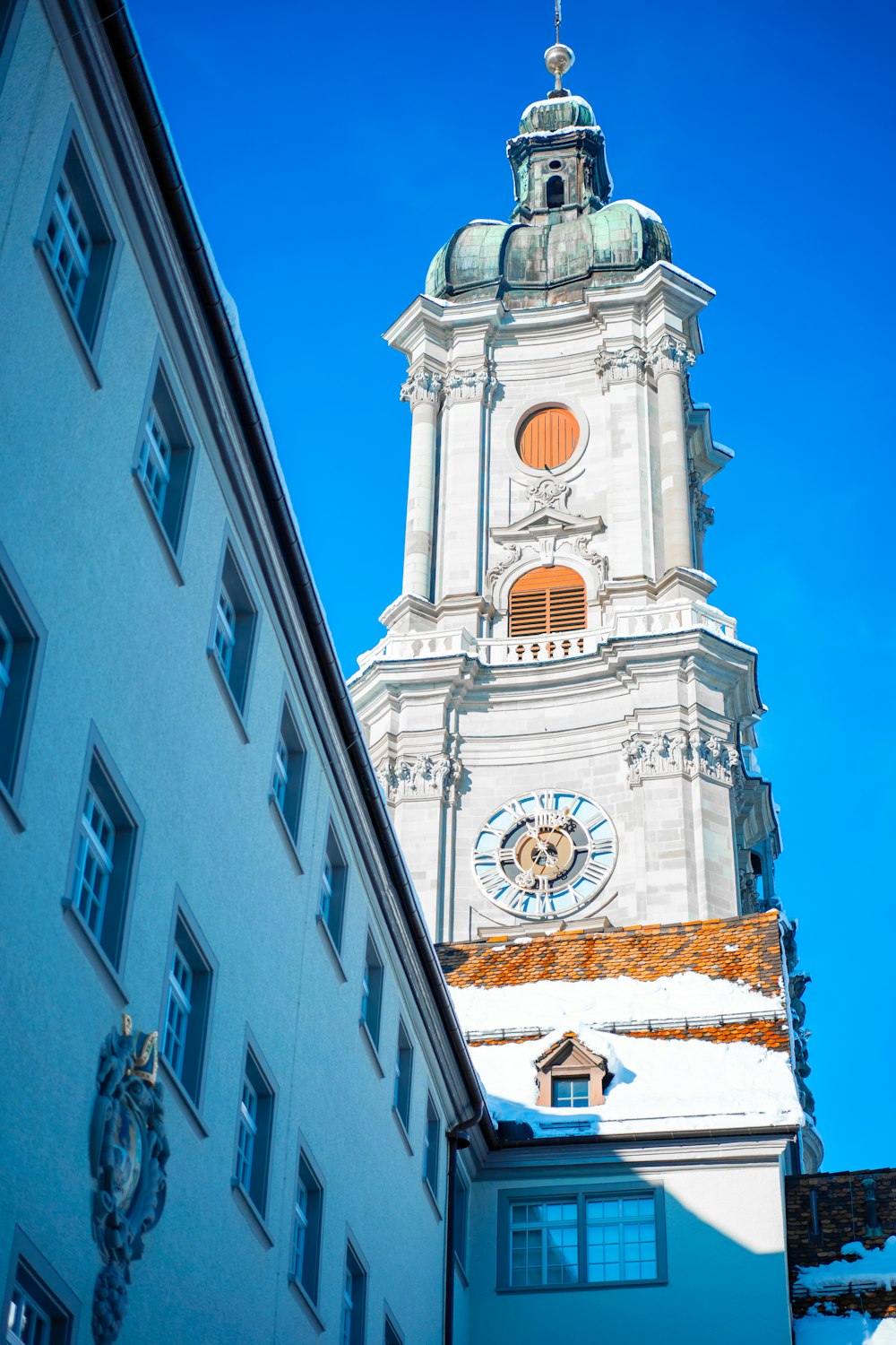 a tall white building with a clock on it's side