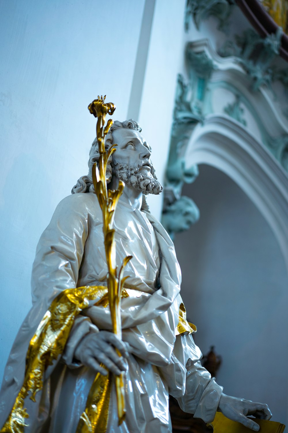 a statue of a man with a cross in his hand