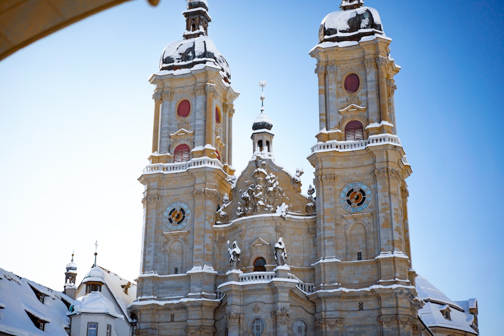 a large church with two towers covered in snow