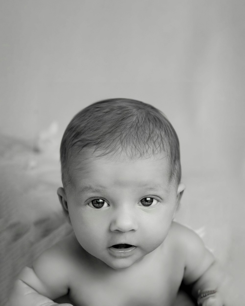 a black and white photo of a baby