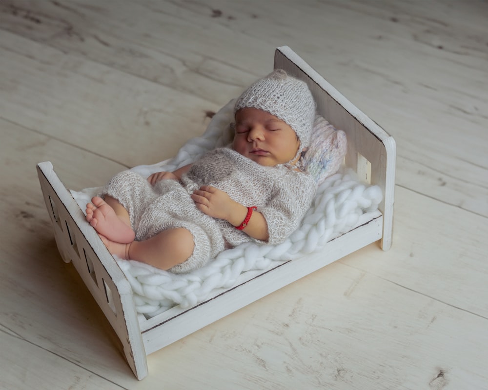 a baby is sleeping in a wooden box